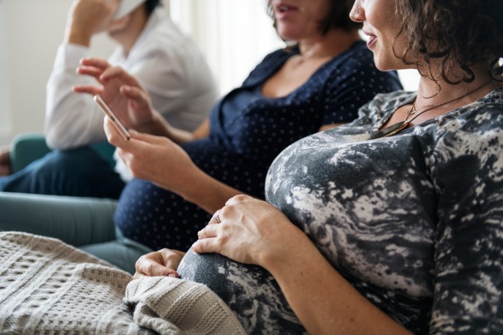 Pregnant support group meetup in a house. rebuilding the village of modern motherhood and parenting