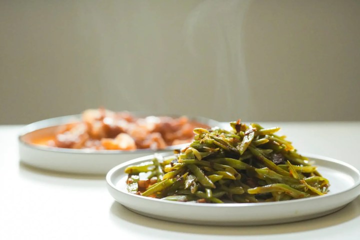 healthy postpartum meals, steaming green beans and stew on white plates